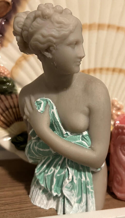 Alabaster statue of Aphrodite, with her garment hand-painted with the texture of rippling shallow water, hemmed in seafoam
