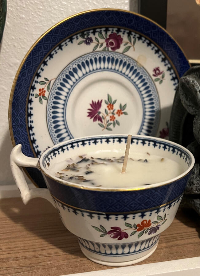 repurposed vintage teacup candle, made with rich coco-soy wax with hand-blended scent of lavender, lime, and tobacco; topped with lavender buds